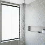 Modern shower head running clear water in a bright bathroom