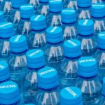 Single-use plastic water bottle on a kitchen counter in natural light