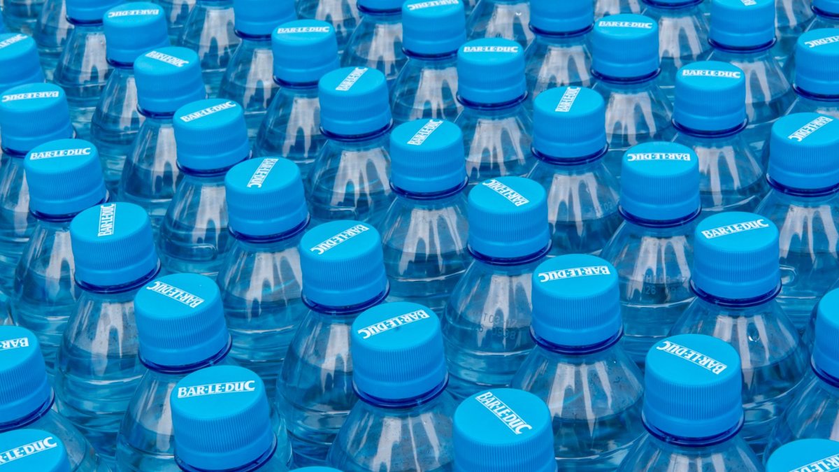 Single-use plastic water bottle on a kitchen counter in natural light