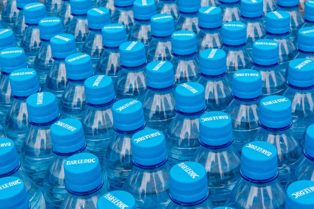 Shrink-wrapped 40-pack of plastic water bottles on a warehouse pallet