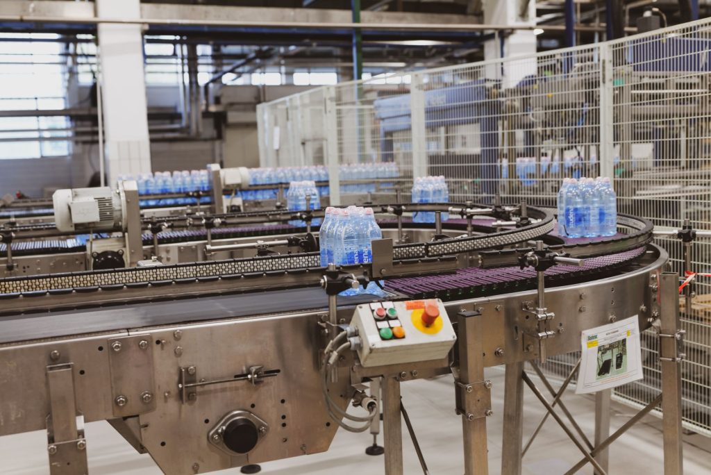 Plastic water bottles moving along a bottling plant conveyor line